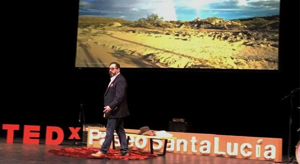 Mauricio giving a TED talk